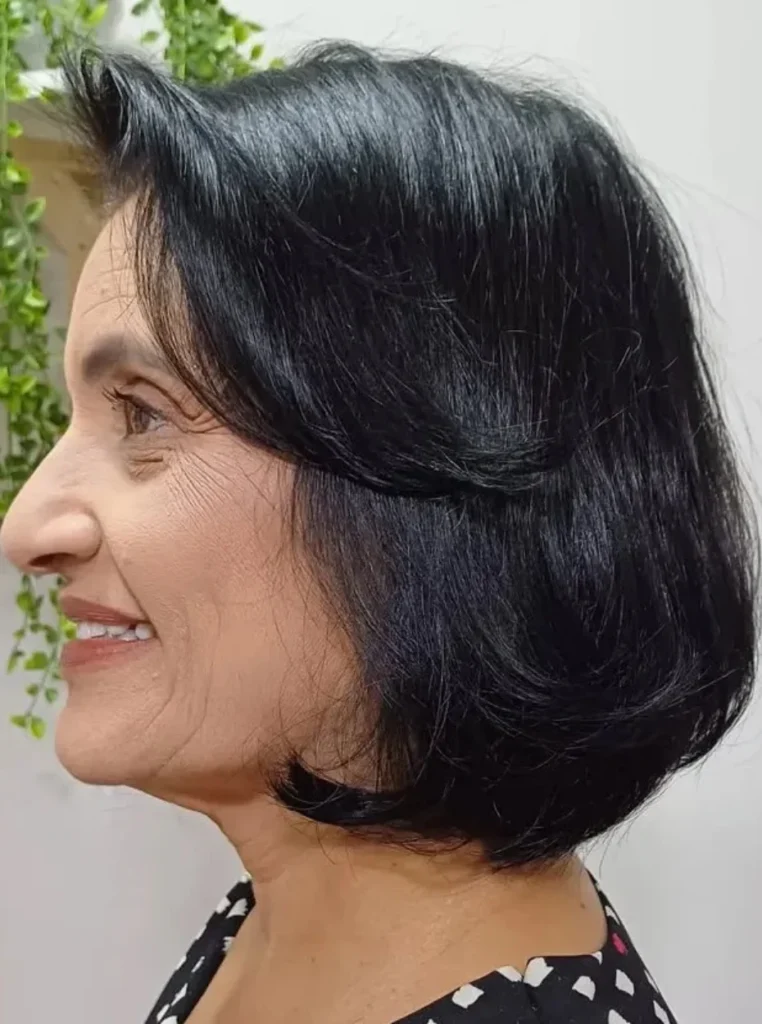 Frau über 60 mit Layered Bob, dunklem glänzendem Haar und sanften Stufen für mehr Volumen, Bewegung und einen eleganten Look.