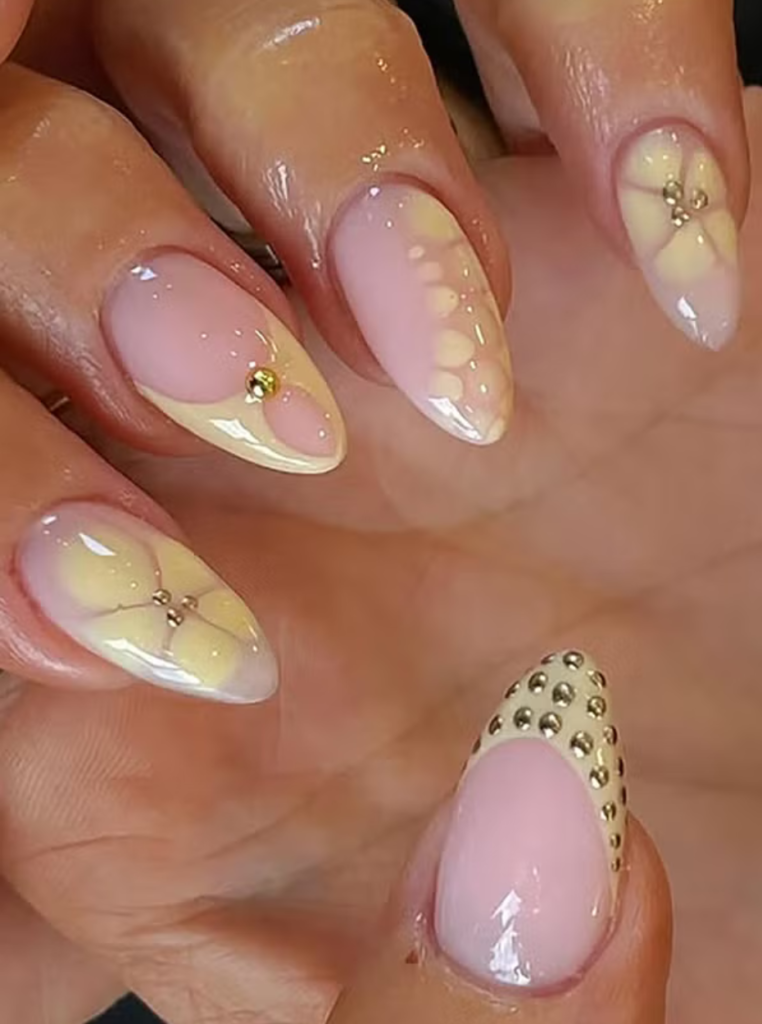 Pastellgelbe Nägel mit floralem Akzent und natürlichem Look
