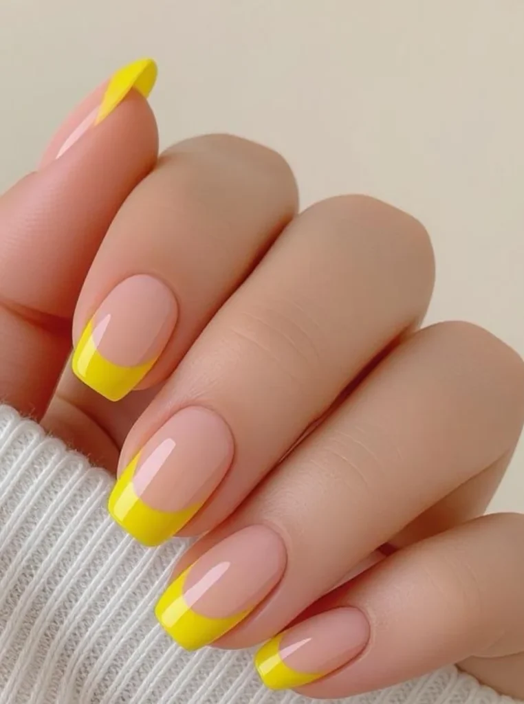 Pastellgelbe Nägel mit French Spitzen und natürlicher Nude Basis
